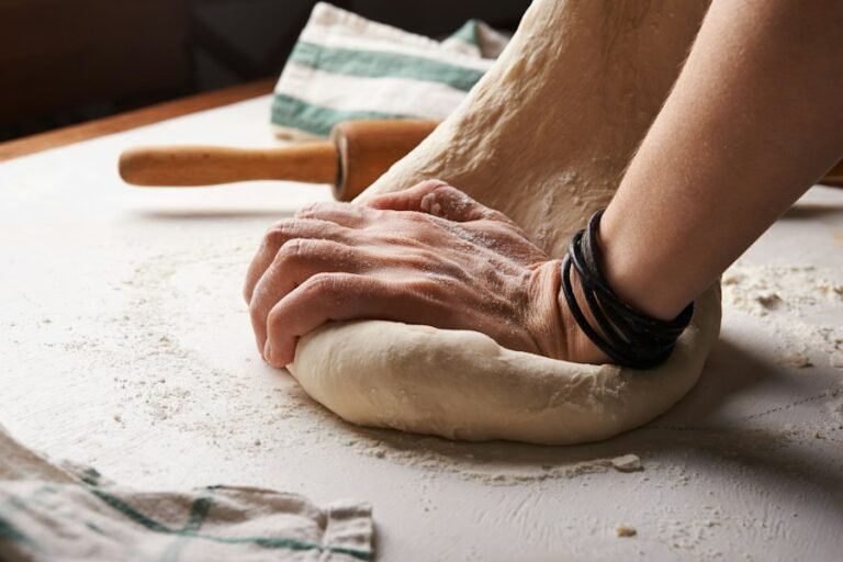 Baker working dough with a rolling pin